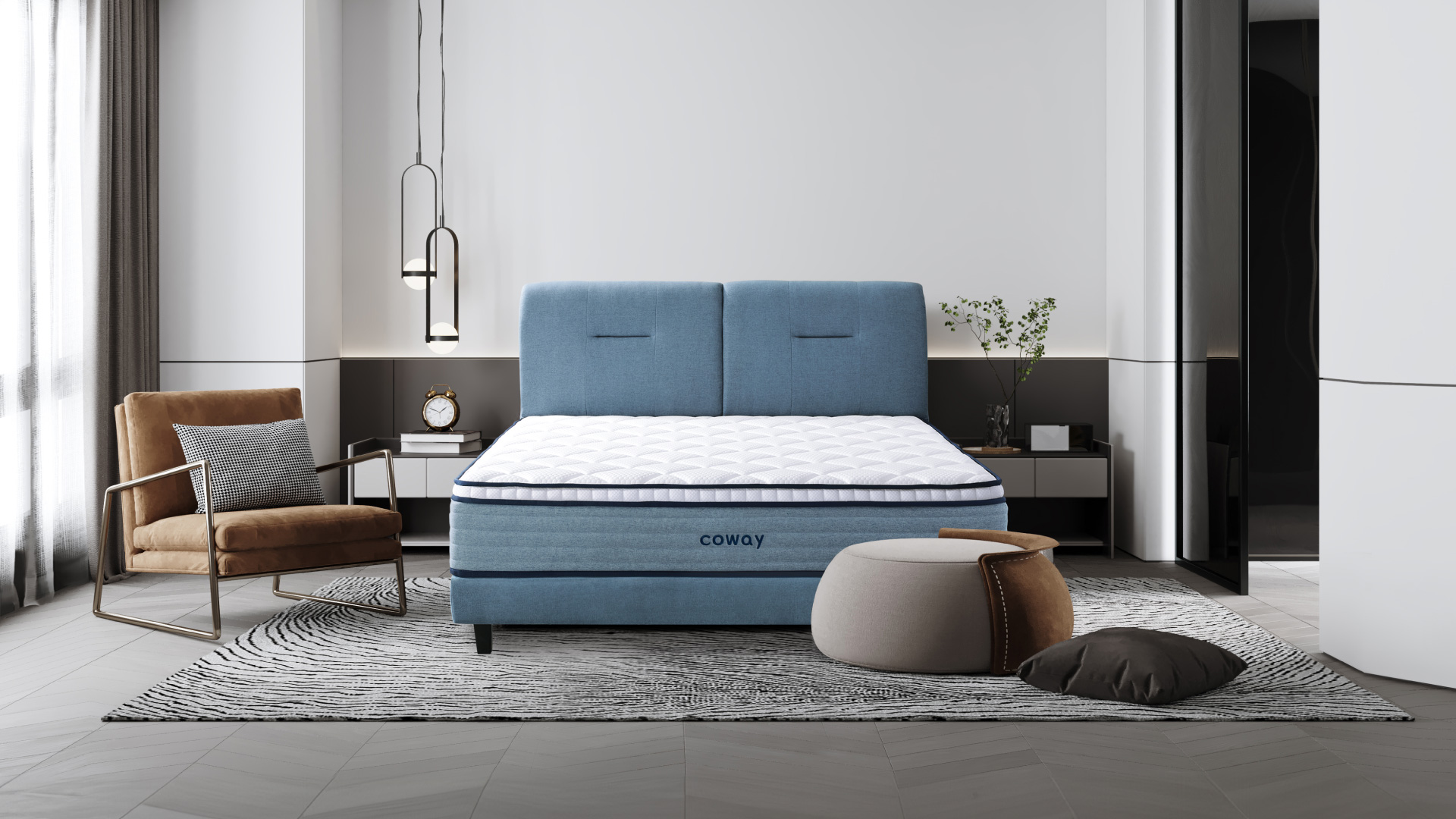 coway-prime-lite-series-mattress-at-the-center-of-the-room-with-an-armchair-and-a-footrest-with-a-pillow-on-the-floor.jpg